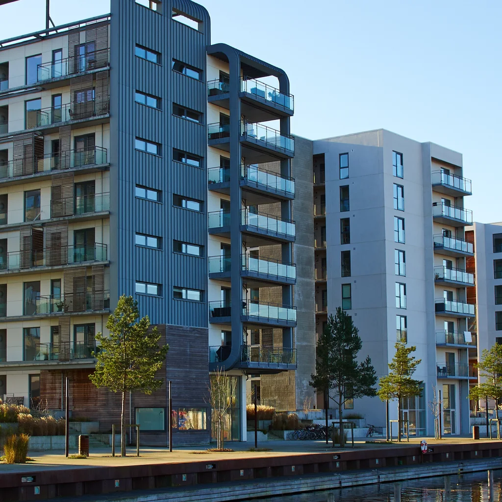 Photo of apartment buildings next to the water. Photo from Adobe Stock images.